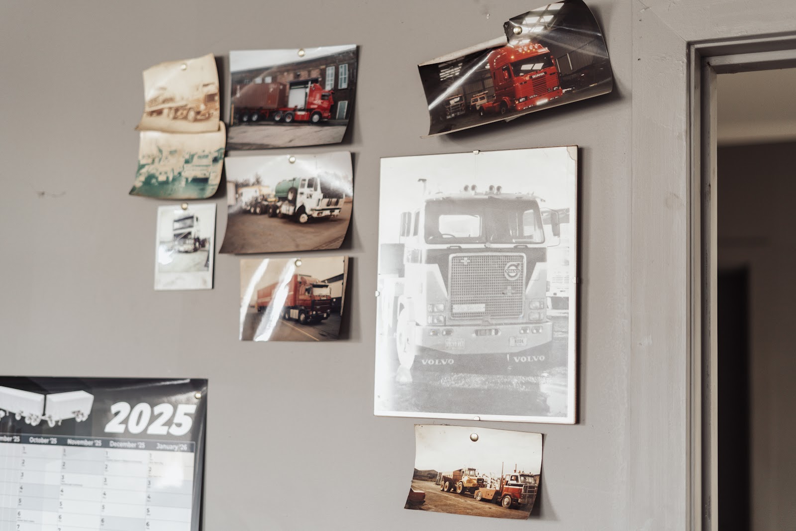 Photographs of the family's UK trucks pinned to the office wall